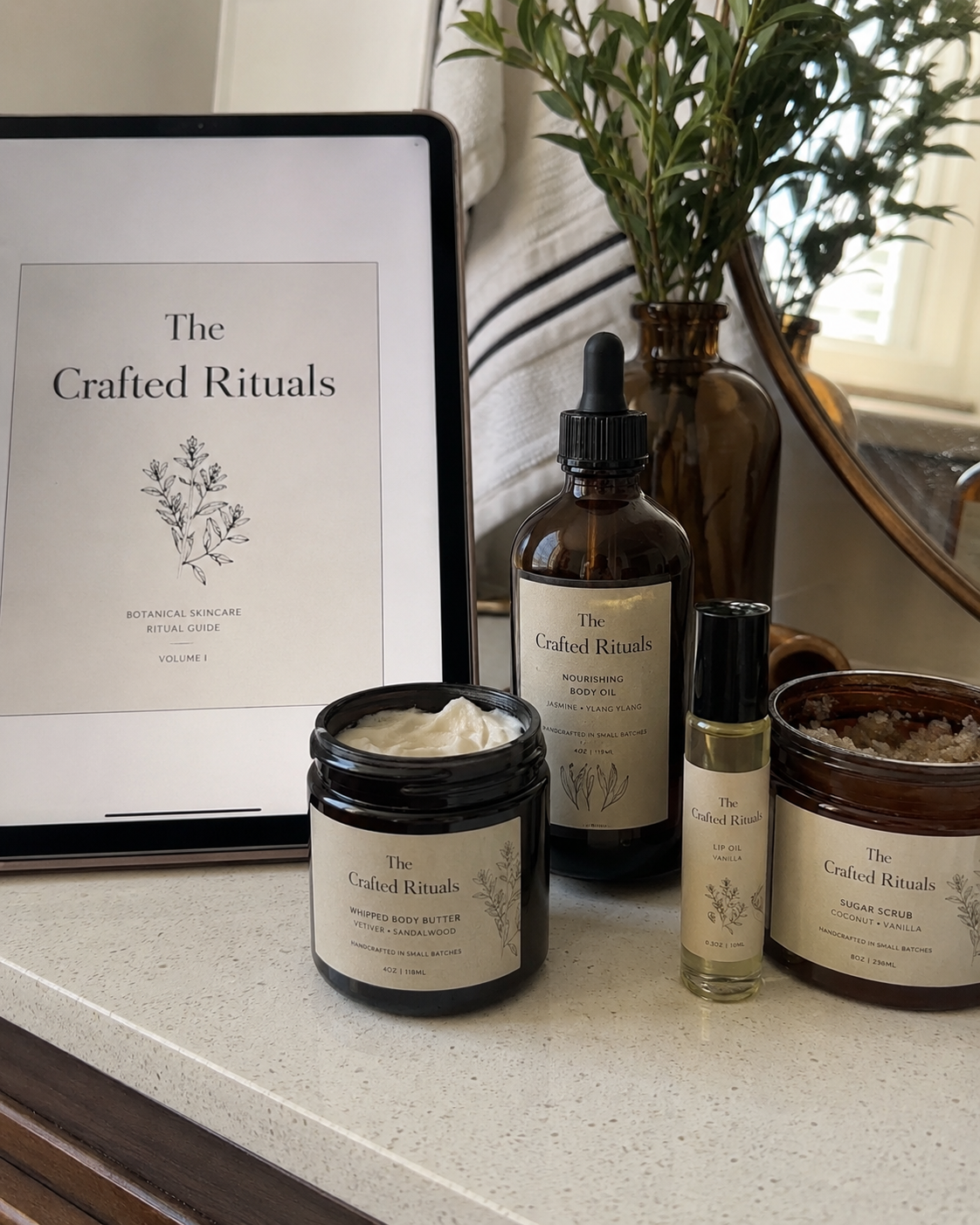 The Crafted Rituals digital guide displayed on a tablet beside handmade body care products